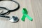 Liver Cancer Awareness, green Ribbon with stethoscope for supporting people living