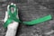 Liver Cancer Awareness ribbon Emerald Green color ribbon on human hand aged background, clipping path: Satin fabric symbolic logo