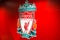 Liverpool, England, United Kingdom; 10/15/2018: Liverpool`s FC badge or emblem with red background inside of Anfield Stadium