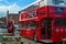 Liverpool, England, United Kingdom; 10/15/2018: Red food truck offering street food in Albert Dock with tables and a red telephone
