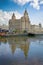 Liverpool waterfront with the The Royal Liver Building in the foreground & reflections of the city in the Mersey river, Liverpool