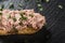 Liverwurst Sandwich with chopped parsley on a dark slate - close