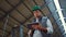 Livestock worker holding tablet computer in shed. Dairy production professional