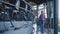 Livestock worker inspecting milking carousel at countryside. Farmer check parlor