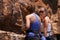 Living on adrenaline. Two female rock climbers preparing for their climb.