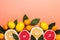 Living coral background with fresh citrus fruits. Healthy food concept