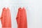 Living Coral knitted warm sweaters on hanger and many empty hangers. Color of the 2019 year