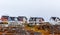 Living Inuit houses among the rocks and mountain in the backgro