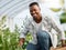 Living more sustainably just makes more sense. Portrait of a young man tending to crops on a farm.