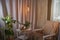 Living room with armchair, window, fabric curtains, home flower dieffenbachia and gentle light and lighting. Loft style