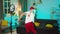 In the living room attractive dancing man influencer making funny video for his social media account recording video on
