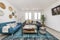 Living room with a blue fabric sofa, another gray three-seater,