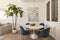 Living room with blue velvet chairs, round marble table, fruit bowl