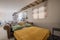 Living room with brown leather chester sofa bed, mustard-colored blanket