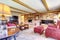 Living room interior with brick fireplace, wood beams and red.