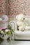Living room interior corner with teddy bear, wall paper,clock, vases and flowers