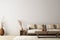 Living room interior mockup in wabi-sabi style with low sofa, jute rug and dried grass decoration