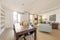 Living room with large wooden dining table and black resin chairs