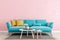 Living room millennial pink interior wall mock up with light blue sofa, empty white wall with free space above on top