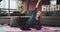 In living room modern design blonde lady practicing flexible yoga poses in the morning on the mat , she have meditation