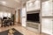 Living room with plaster bookcase with glass doors and shelves,