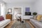 living room with sofas upholstered in fabric, wooden sideboard