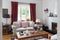 Living room very bight with fireplace, oak wooden floor, red curtins, a trunk and retro objets, Greece