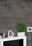 Living room wall design with modern slates texture and potted grass.