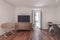 Living room with wooden sideboard and tv above it, wooden