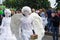 A living statue of an angel walks down the street amid people, at the celebration of Europe Day