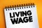 Living Wage text on notepad, concept background