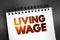 Living Wage text on notepad, concept background