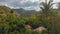 Living in wild. Small houses bungalow with red roof in Thai jungle, Koh Chang, Thailand. Panoramic asian countryside landscape