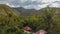 Living in wild. Small houses bungalow with red roof in Thai jungle, Koh Chang, Thailand. Panoramic asian countryside landscape
