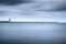 Livorno port lighthouse, breakwater and soft water under cloudy