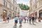 LJUBLJANA, SLOVENIA - AUGUST 15, 2018: A large cobbled pedestrian street with high old buildings presents the city Castle to the
