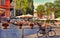 LJUBLJANA, SLOVENIA -  JUNE 28, 2019: Street view in Ljubljana city center, small outdoor cafe with tourists. LJUBLJANA, JUNE 28,