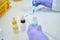 Llaboratory assistant drops blue reagent from pipette onto indicator palette