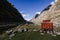 .Llamacorral camp sign next to tents and snowy mountains in the background in the quebrada santa cruz