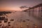 Llandudno tourism. Long exposure of Llandudno pier at low tide with a warm sunset.