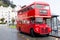 LLandudno, Wales, UK - MAY 27, 2018 Londons red double decker car parked on the road. buses on the stop. Tourism and touristic t