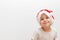 Llittle boy in Santa Claus hat looking at camera on white background. Postcard. Waiting for Xmas, Happy new year. Copy space