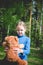 Llittle cute girl play with teddy bear on summer outdoors. Best Friend Concept. Best Friend Concept