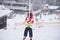 Llittle skiing girl holding tight a handle of a ski tow