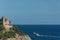 Lloret De Mar, Spain - 09/28/2019: Seascape. An old castle and a ship sailing away