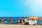 Lloret de mar, Spain - July 11, 2019: Yacht on the beach. Guys and girls on the background of the sea.