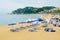 LLORET DE MAR, SPAIN - JULY 28, 2019: Empty sun lungers on beach on an early morning in Costa Brava. Concept of rest. Summer