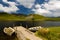 Llyn y Dywarchen Reservoir with two rowing boats by jetty, Snowdonia.