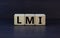 LMI  lenders mortgage insurance symbol. Wooden cubes form the word \\\'LMI  lenders mortgage insurance\\\'.