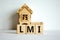 LMI  lenders mortgage insurance symbol. Wooden cubes  the word \\\'LMI  lenders mortgage insurance\\\'.